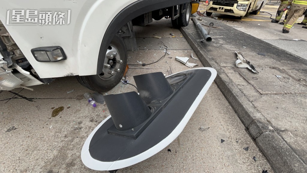 交通灯柱撞毁，灯罩跌在路上。杨伟亨摄