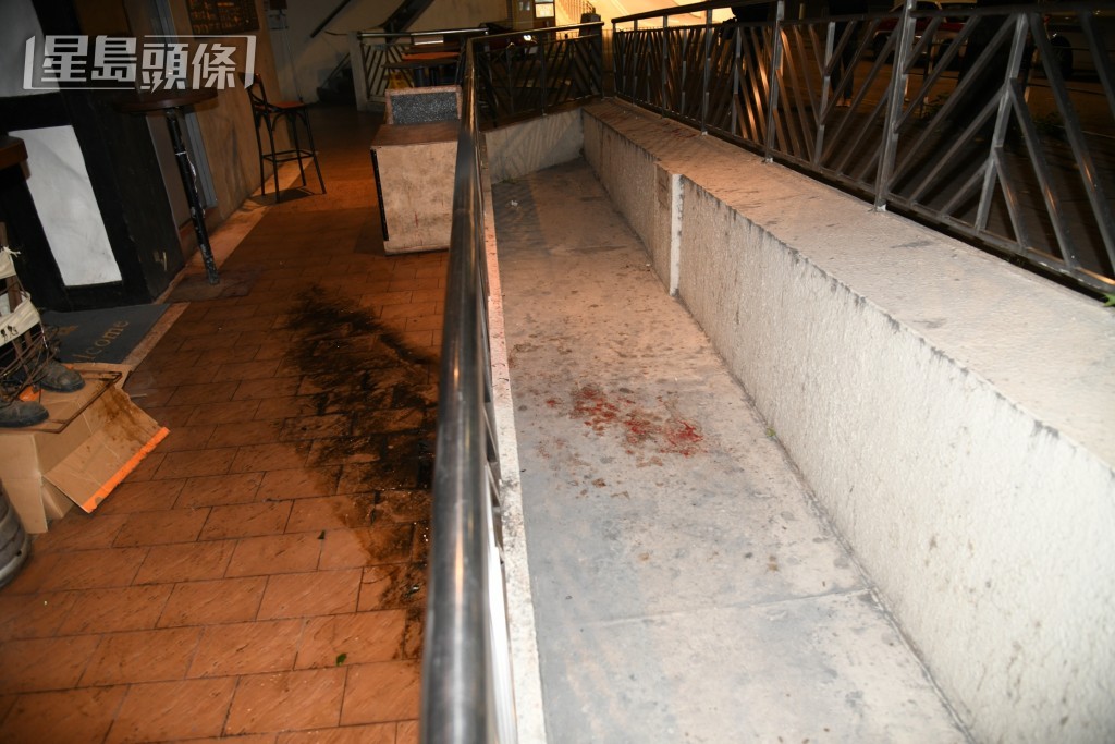 建新中心遭两黑衣人纵火。黎志伟摄