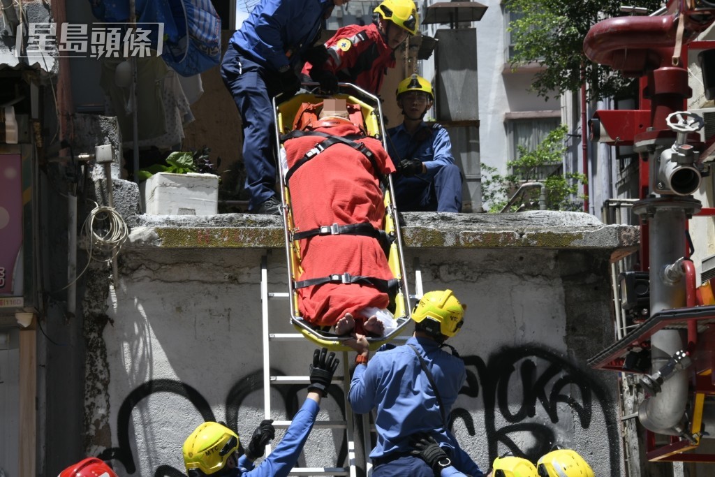 消防員將男子救下送院。楊偉亨攝 消防員將男子救下送院。楊偉亨攝