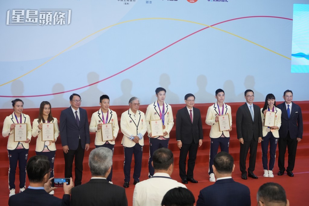 李家超向在亚运中获奖的运动员颁发表扬状。吴艳玲摄