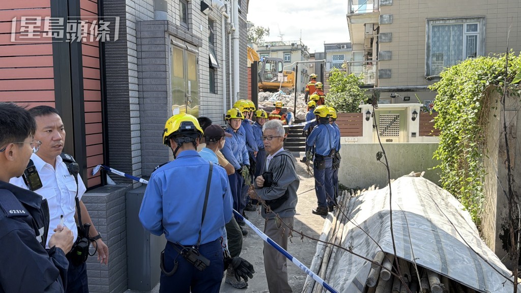 鄰屋屋主到場查看塌牆情況。
