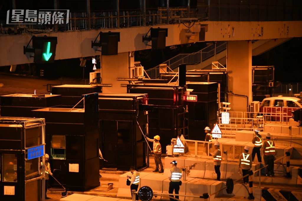 工人將收費亭塗上黑色油漆，實施易通行將停用。黎志偉攝