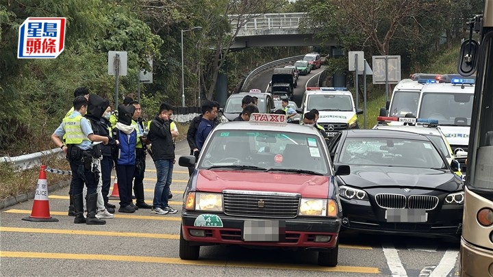 寶馬男司機及女乘客被黑布蒙頭，警員搜查車輛。劉漢權攝