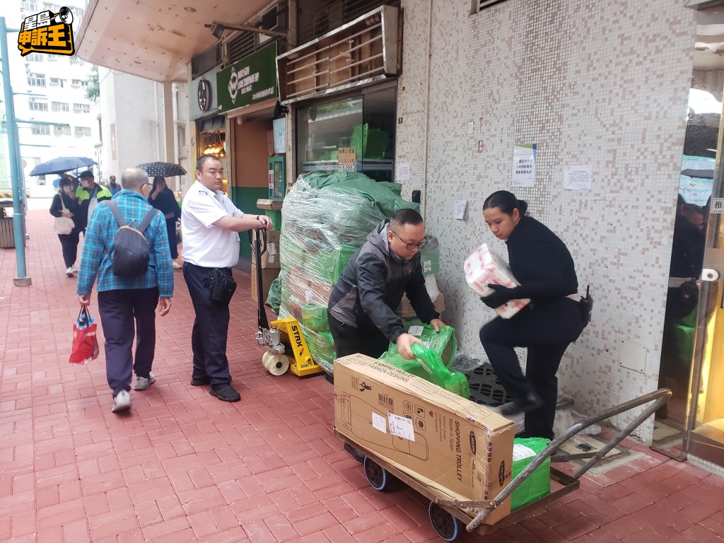多名龍門居保安員採取行動,將自提點店外貨物扣押搬走。 多名龍門居保安員採取行動,將自提點店外貨物扣押搬走。