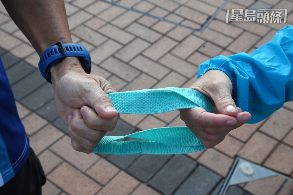 視障跑者要依賴領跑員的語音提示與繩牽引，才能安全奔跑。