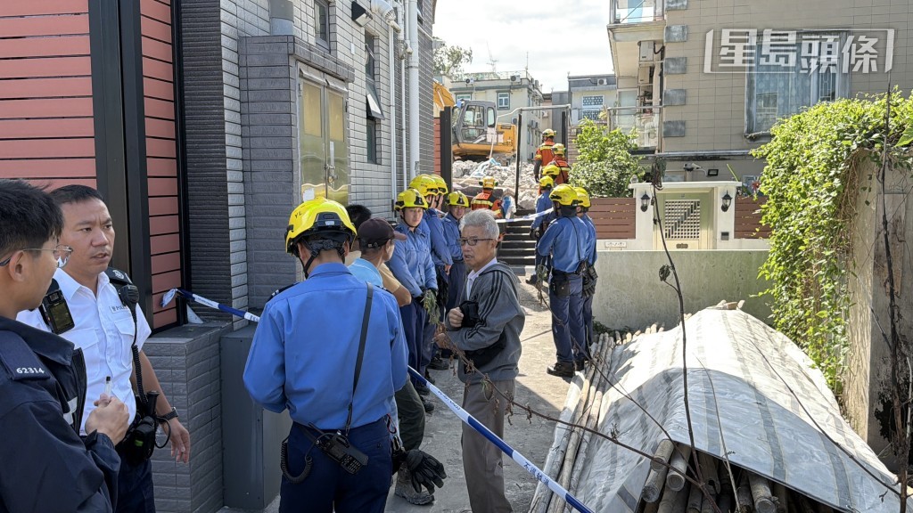 鄰屋屋主到場查看塌牆情況。 鄰屋屋主到場查看塌牆情況。