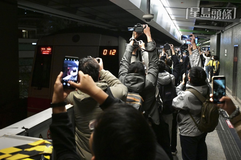 鐵路迷高舉相機送別白頭列車。