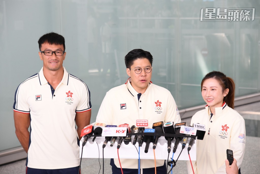 代表團團長霍啟剛，與兩名持旗手見記者。（何健勇攝）
