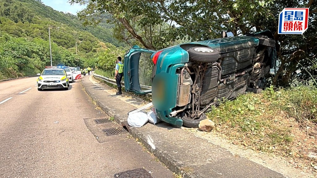 私家車鏟上行人路翻側。劉漢權攝