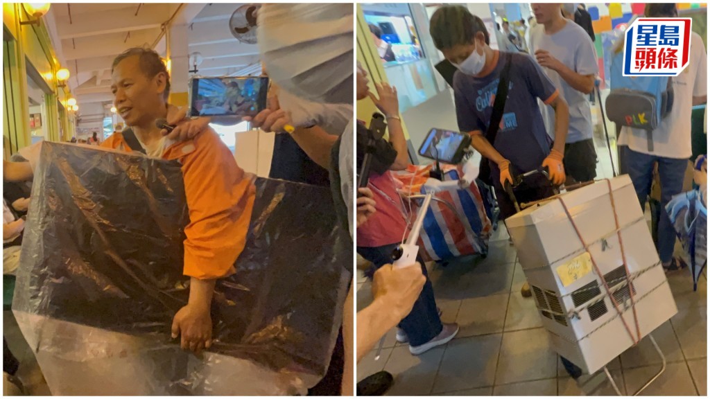 住戶搬走電視機及冷氣機。楊偉亨攝